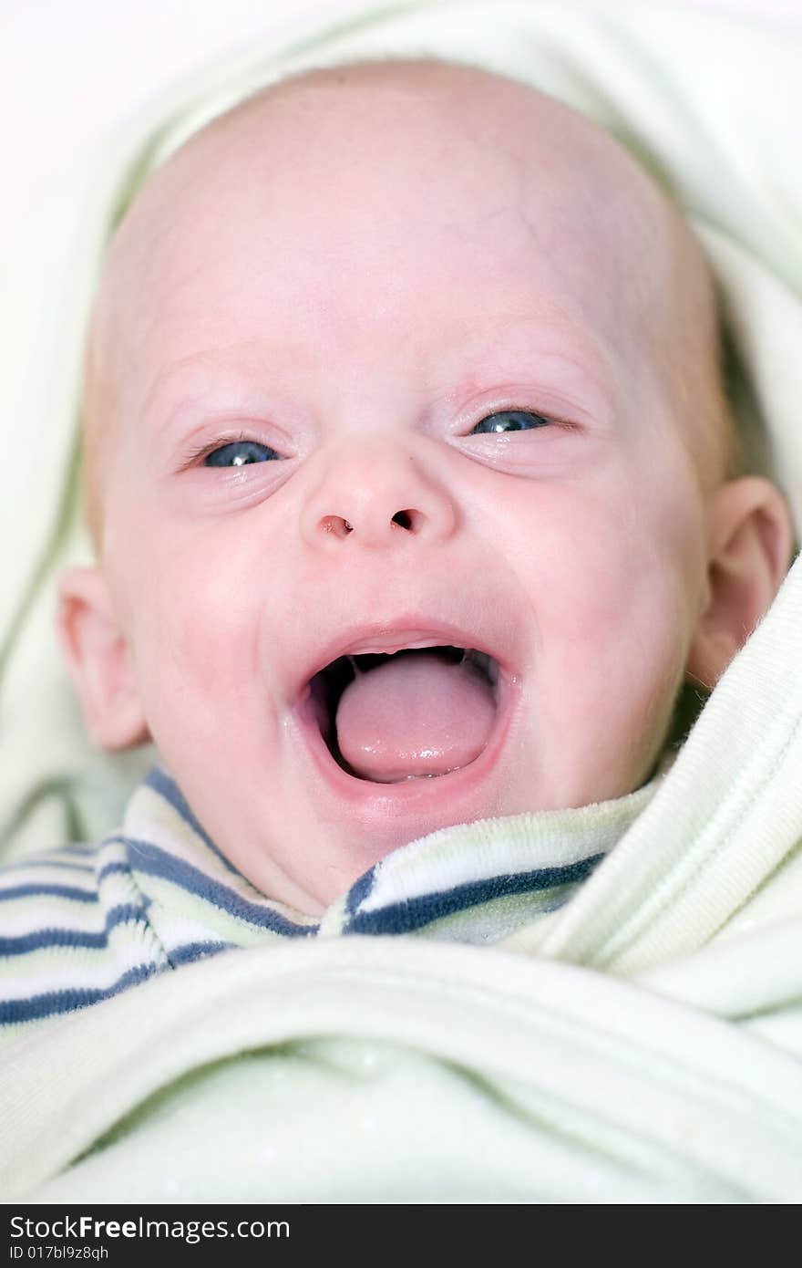 A little cute newborn baby  lying on bed with her eyes open