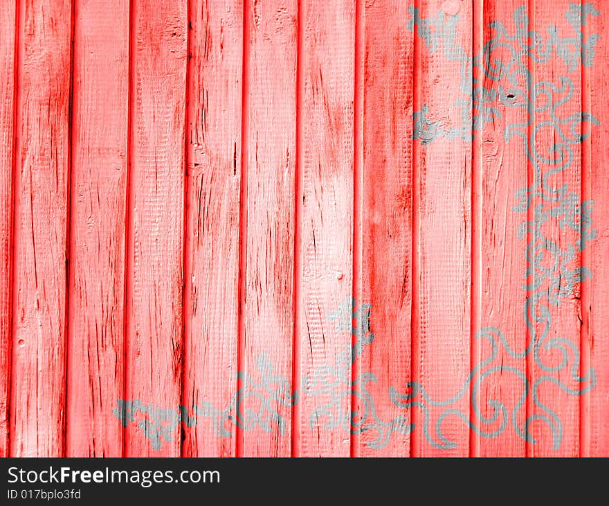 Red wooden fence with ornament.