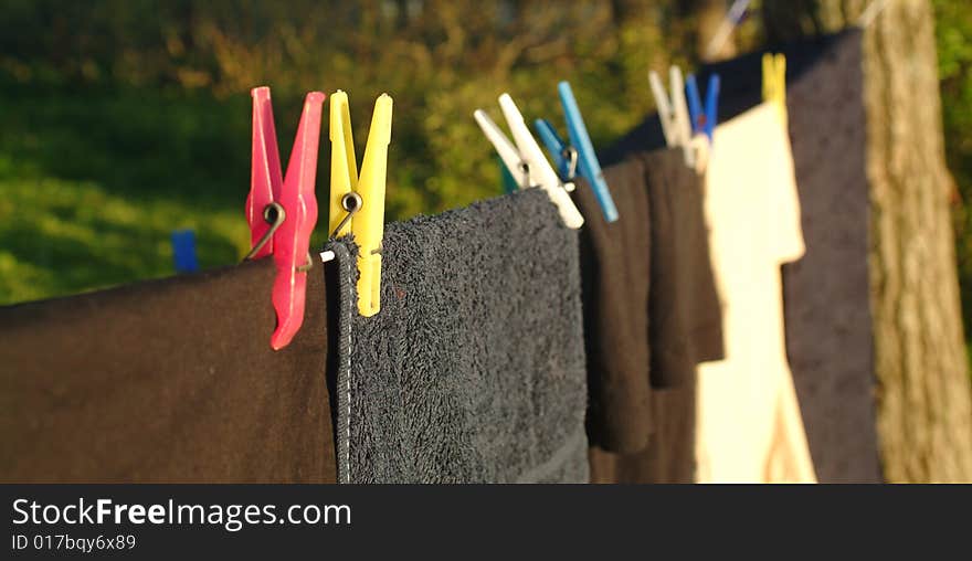 Wet andnewly laundered clothes hung out to dry in the sunlight. Wet andnewly laundered clothes hung out to dry in the sunlight