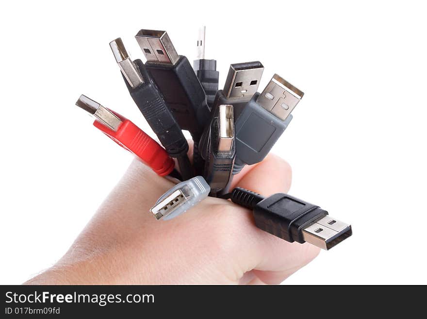 Many usb cables in hand, isolated on white