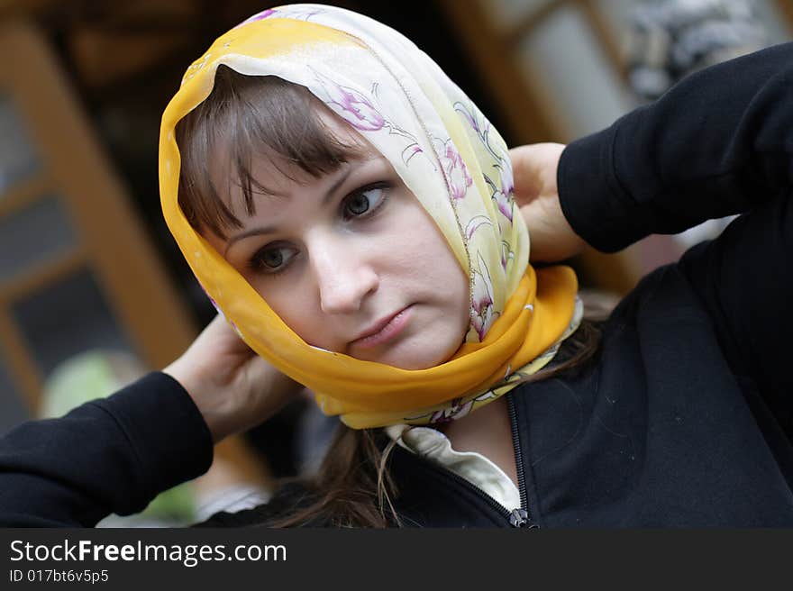 Woman ties kerchief