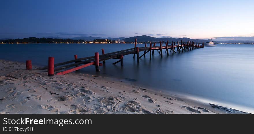 An old red dock at the beach