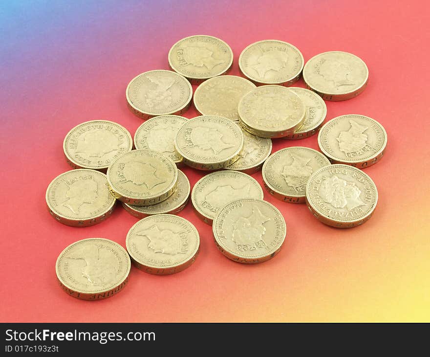 Pounds coins on a colorful (rainbow-like) background