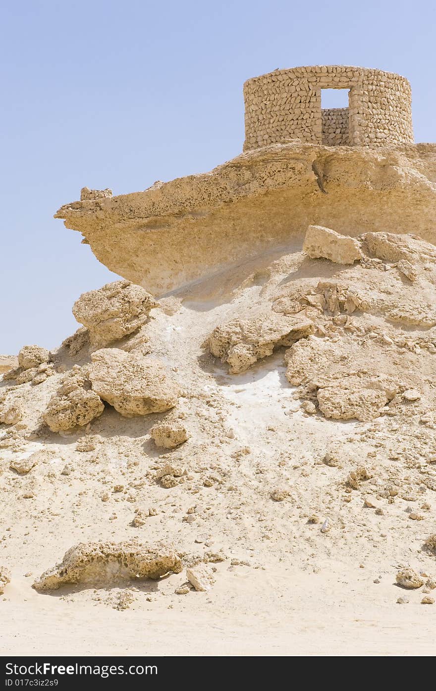 Remote desert landscape with interesting sandstone formations formed millions of years ago. Interesting old reconstructed stone houses are visible. Remote desert landscape with interesting sandstone formations formed millions of years ago. Interesting old reconstructed stone houses are visible.