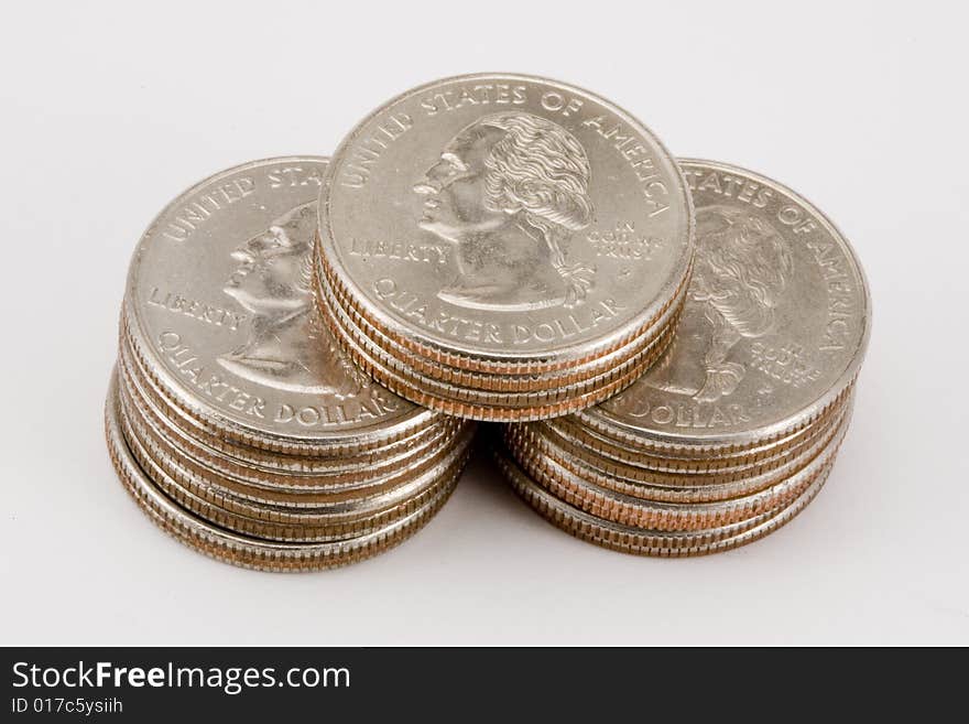 Three stacks of quarters in various heights. Three stacks of quarters in various heights