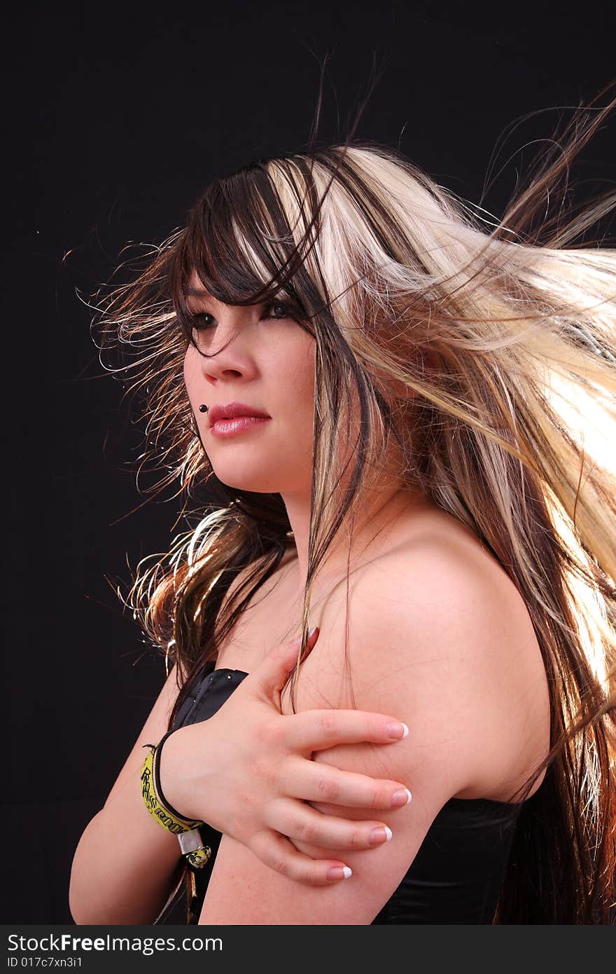 Young woman in studio with moving hair