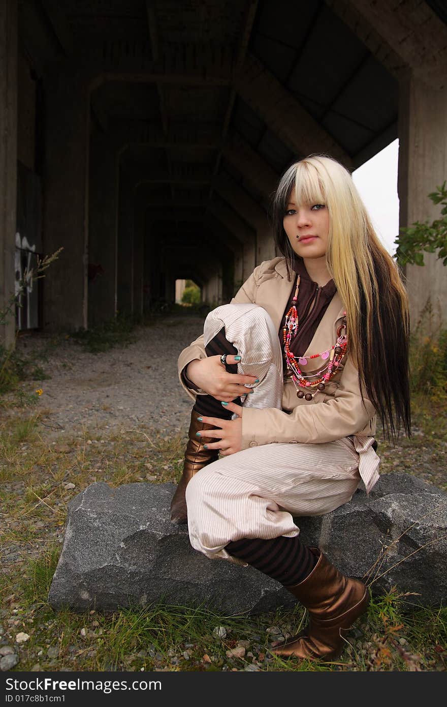 Beautiful young woman, fashion model, black and blond hair in industrial location