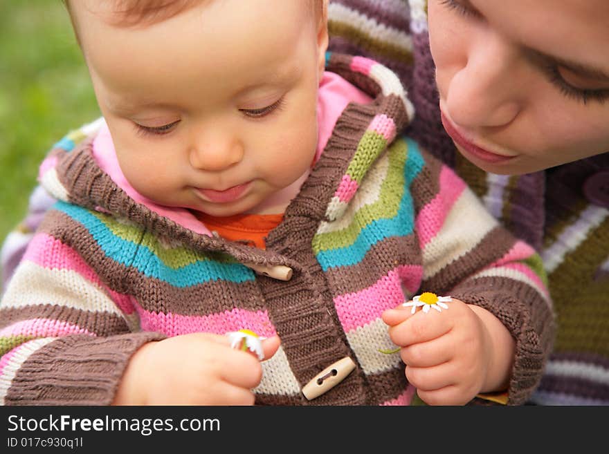 Close-up portrait of mother and baby on nature