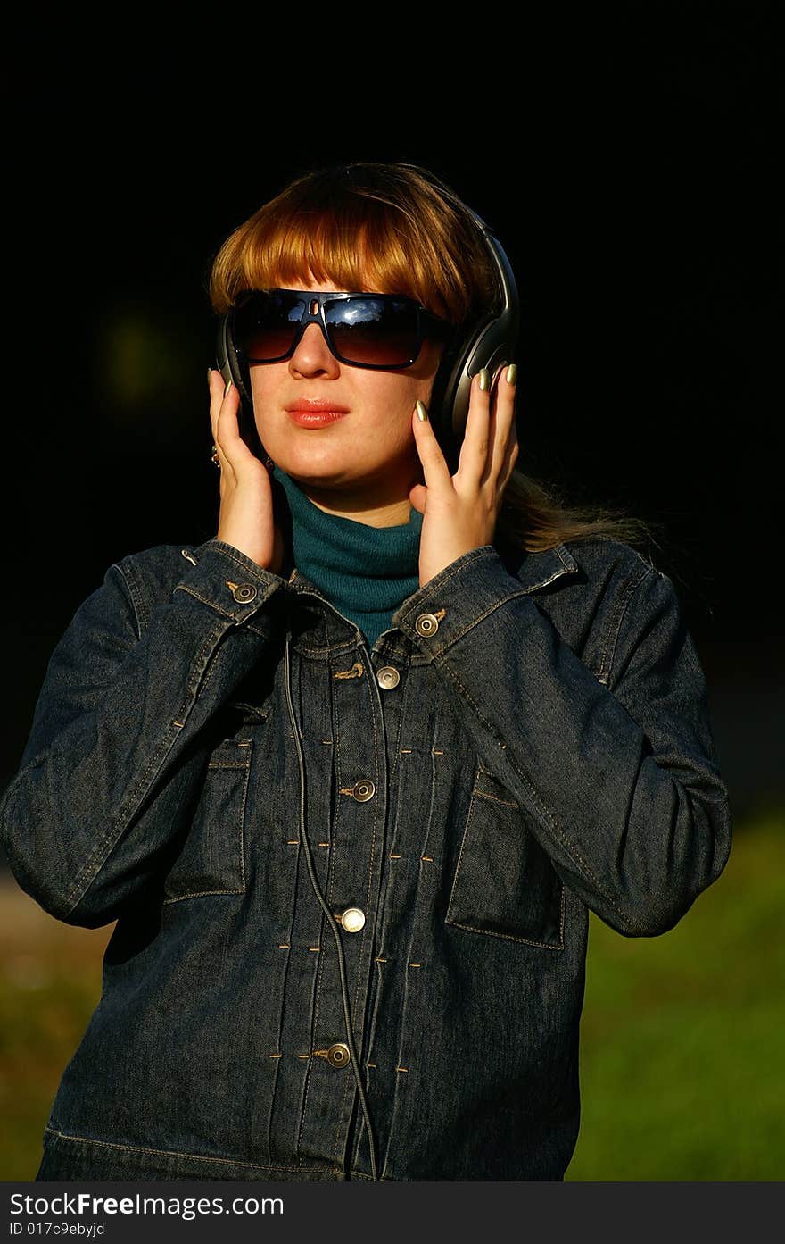 Girl with headphones in glasses