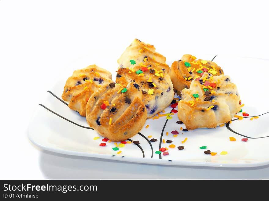 Six isolated fruit cakes on the white plate. Six isolated fruit cakes on the white plate.