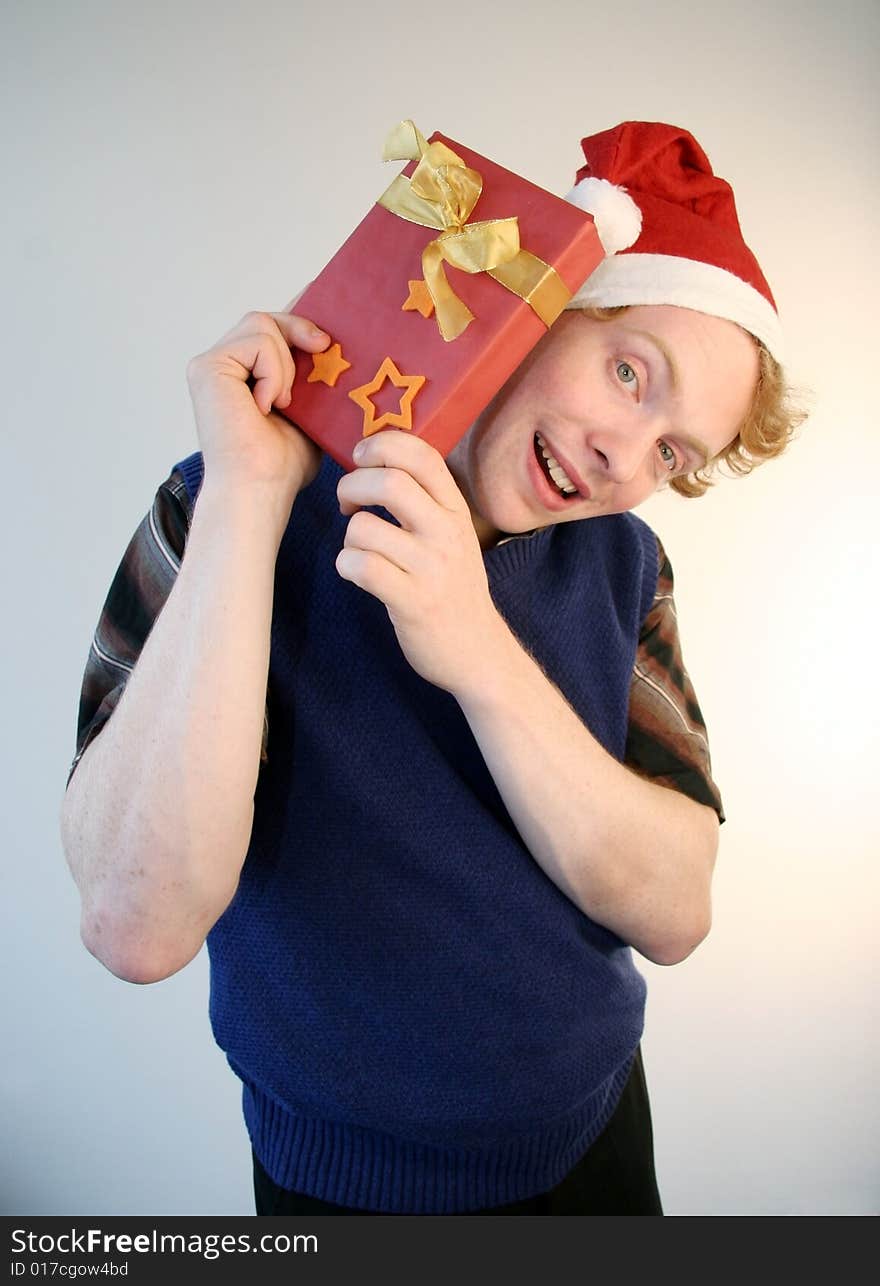 A weird nerd holding up an xmas present gleefully.  A weird nerd holding up an xmas present gleefully.