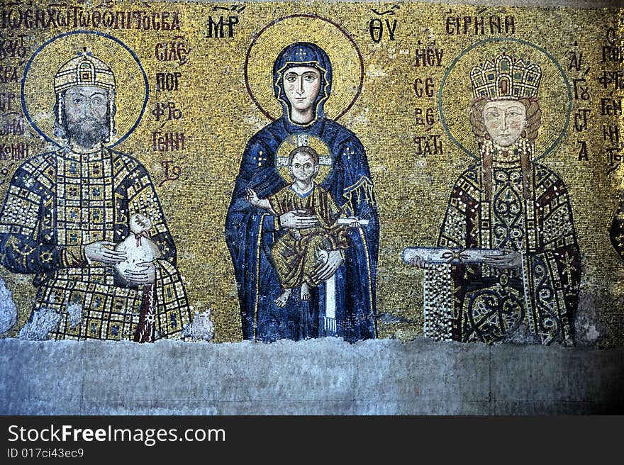 The Comnenus mosaics, equally located on the eastern wall of the southern gallery, date from 1122. The Virgin Mary is standing in the middle, depicted, as usual in Byzantine art, in a dark blue gown. She holds the Child Christ on her lap (wikipedia). The Comnenus mosaics, equally located on the eastern wall of the southern gallery, date from 1122. The Virgin Mary is standing in the middle, depicted, as usual in Byzantine art, in a dark blue gown. She holds the Child Christ on her lap (wikipedia).