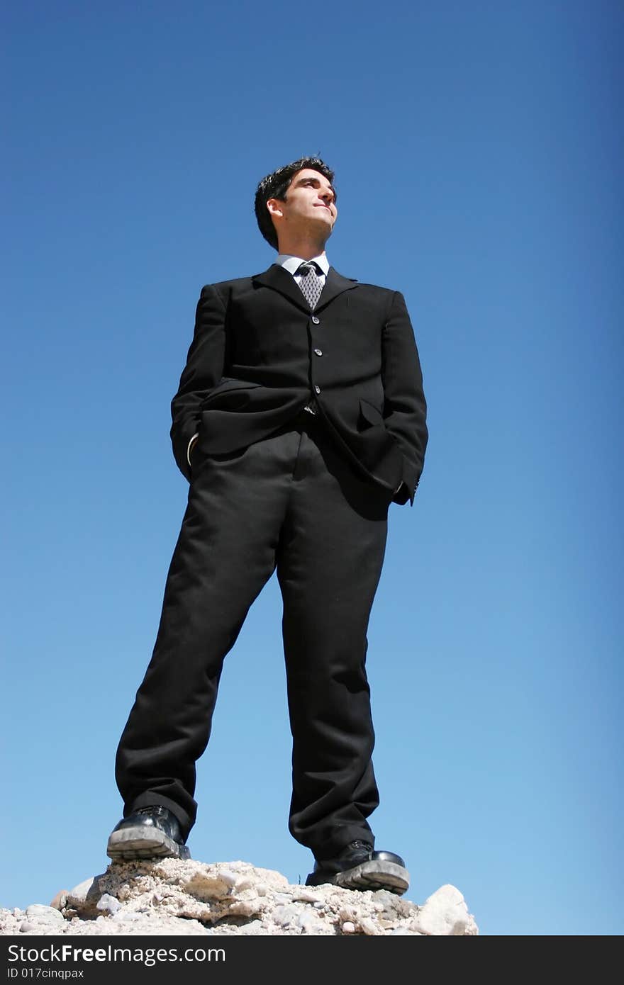 Successful businessman in dark suit showing confidence