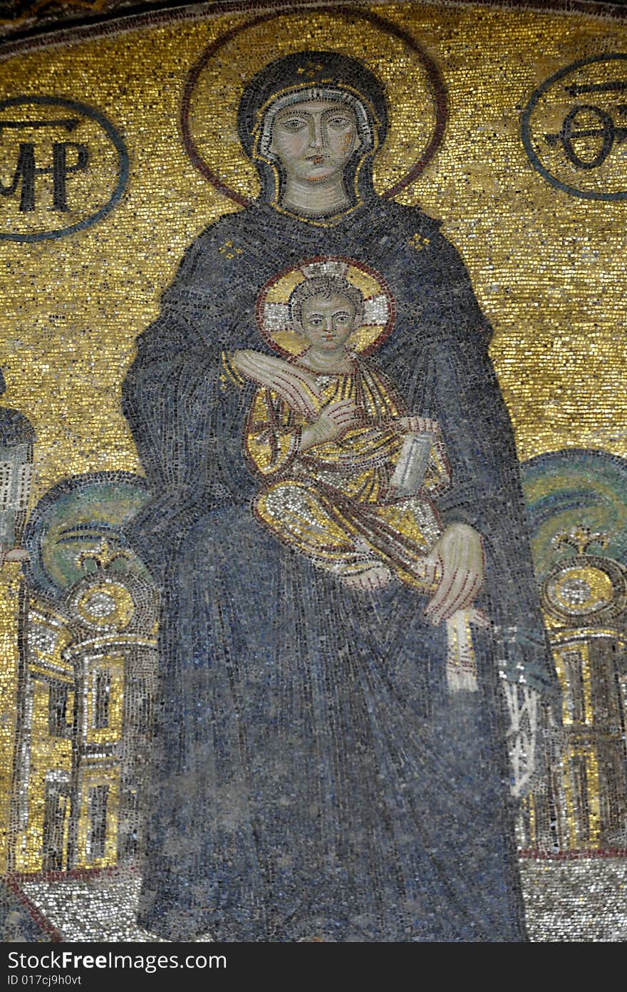 The Comnenus mosaics, equally located on the eastern wall of the southern gallery, date from 1122. The Virgin Mary is standing in the middle, depicted, as usual in Byzantine art, in a dark blue gown. She holds the Child Christ on her lap (wikipedia). The Comnenus mosaics, equally located on the eastern wall of the southern gallery, date from 1122. The Virgin Mary is standing in the middle, depicted, as usual in Byzantine art, in a dark blue gown. She holds the Child Christ on her lap (wikipedia).