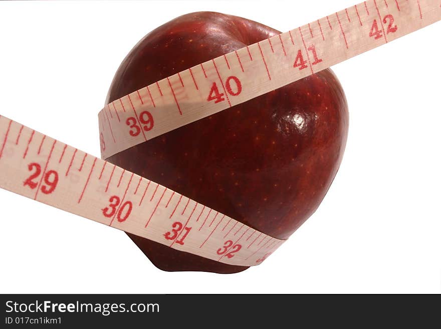 One red apple with measuring tape