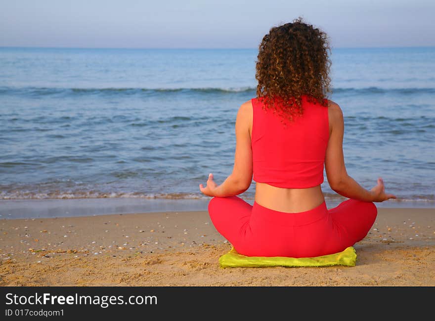 Yoga girl on beach from back, summer