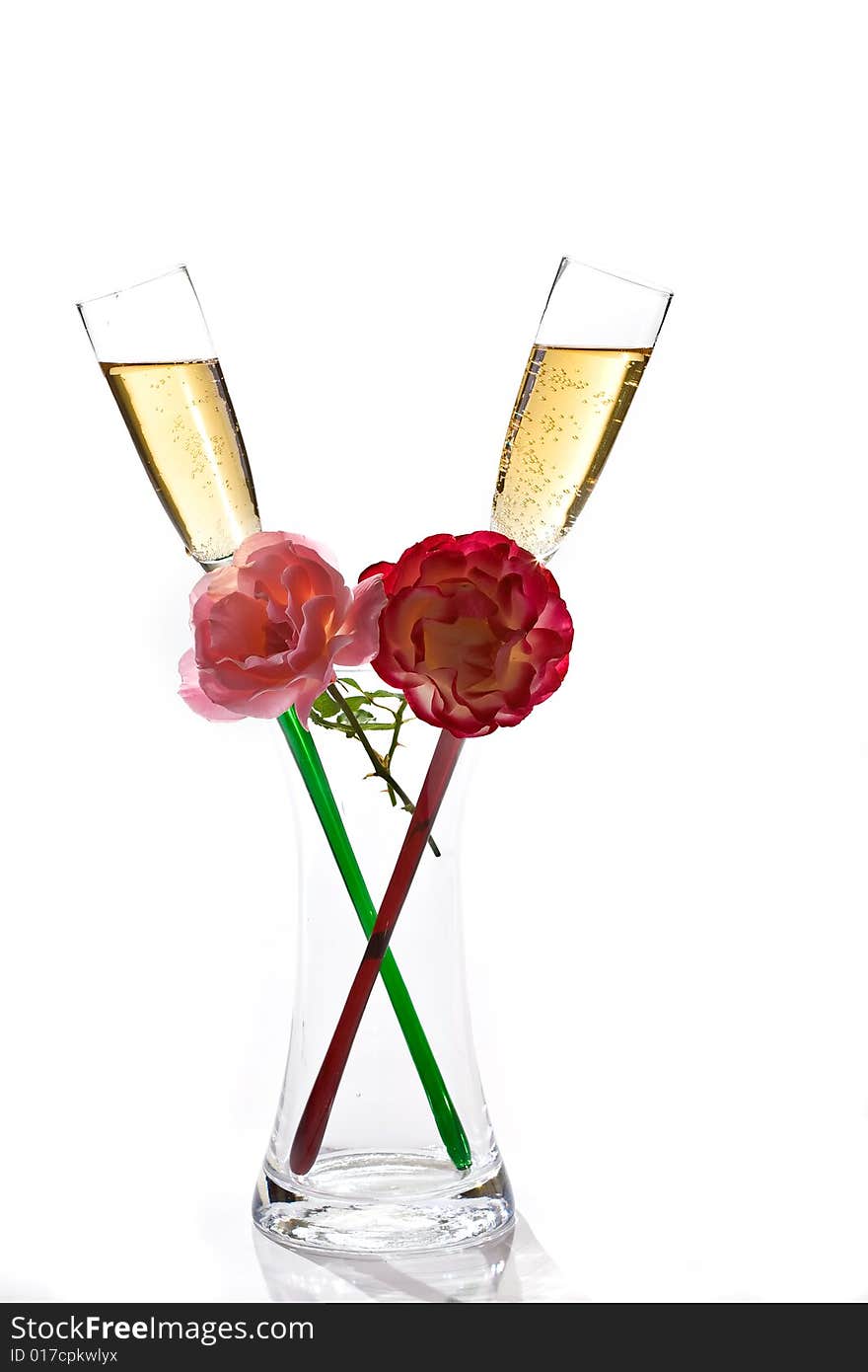 Two flutes of champagne and rose on white background