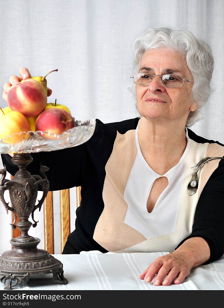 Senior lady looking at the fruits