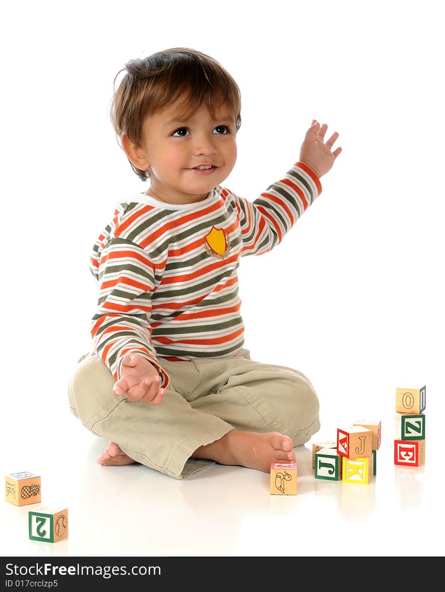 Baby boy delighted with his stacked alphabet blocks. Isolated on white. Baby boy delighted with his stacked alphabet blocks. Isolated on white.