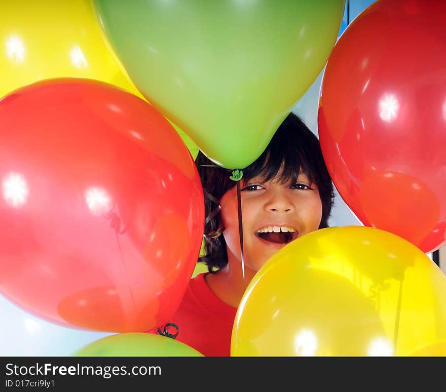 A happy Asian-Indian boy surrounded by colorful balloons. A happy Asian-Indian boy surrounded by colorful balloons.