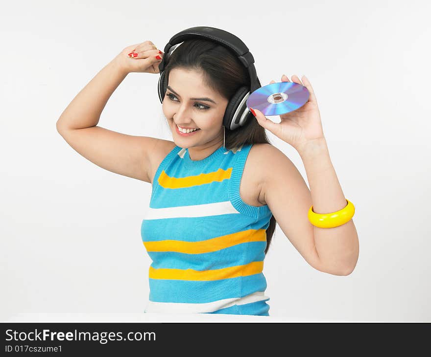 Asian woman of indian origin listening to music. Asian woman of indian origin listening to music