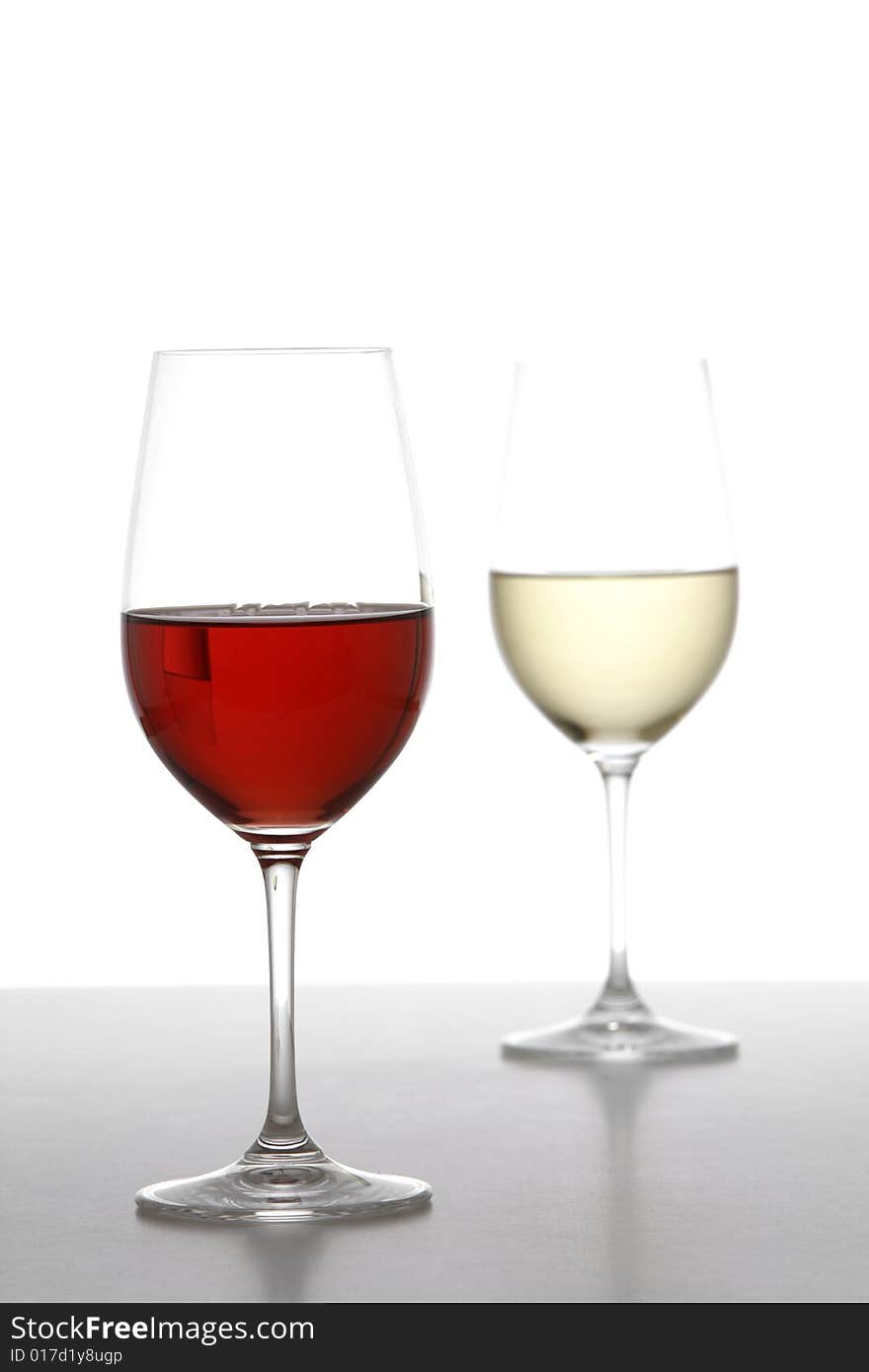 Two wine glasses one red one white in the studio