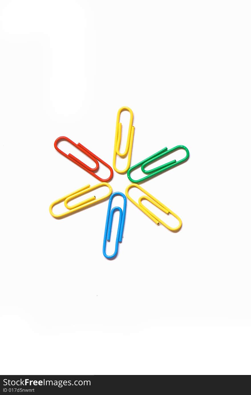 Paper clips in different figures on a white background