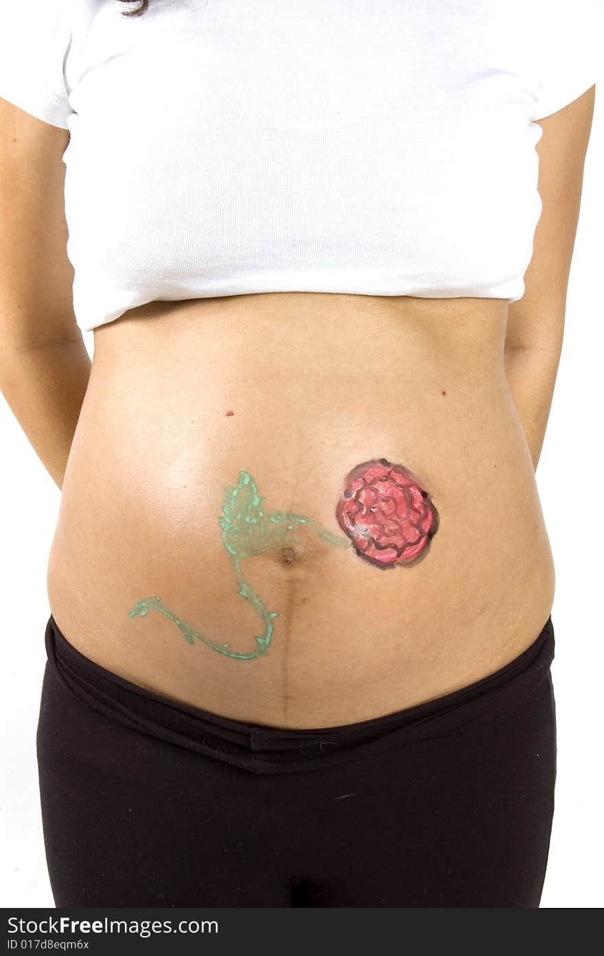 30 weeks pregnant teenager with a flower on her belly