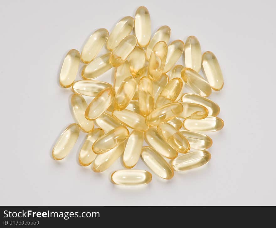 Vitamin Capsules randomly arranged on a white background