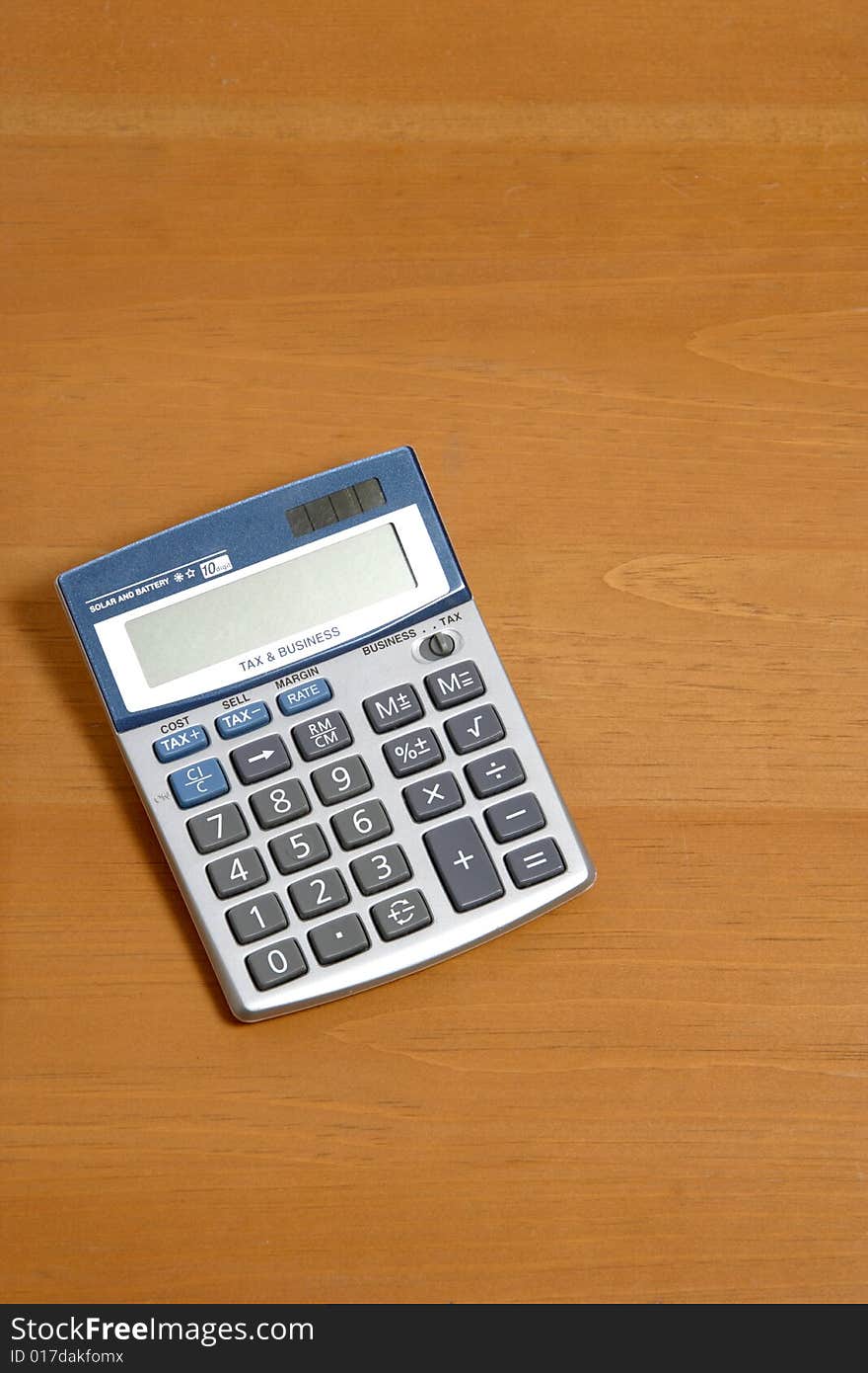 A calculator on a legal pad in an office. A calculator on a legal pad in an office