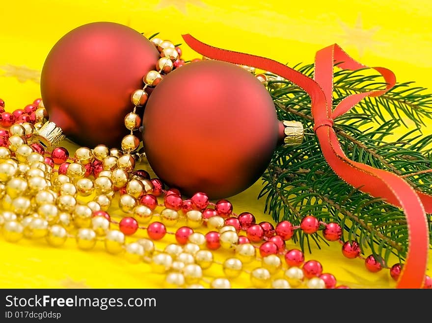 Two red balls with ribbon on the yellow background. Two red balls with ribbon on the yellow background