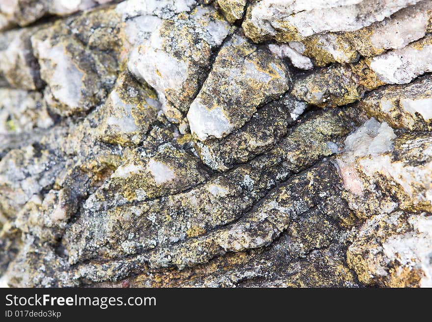 Abstract Rock texture with cracks and moss