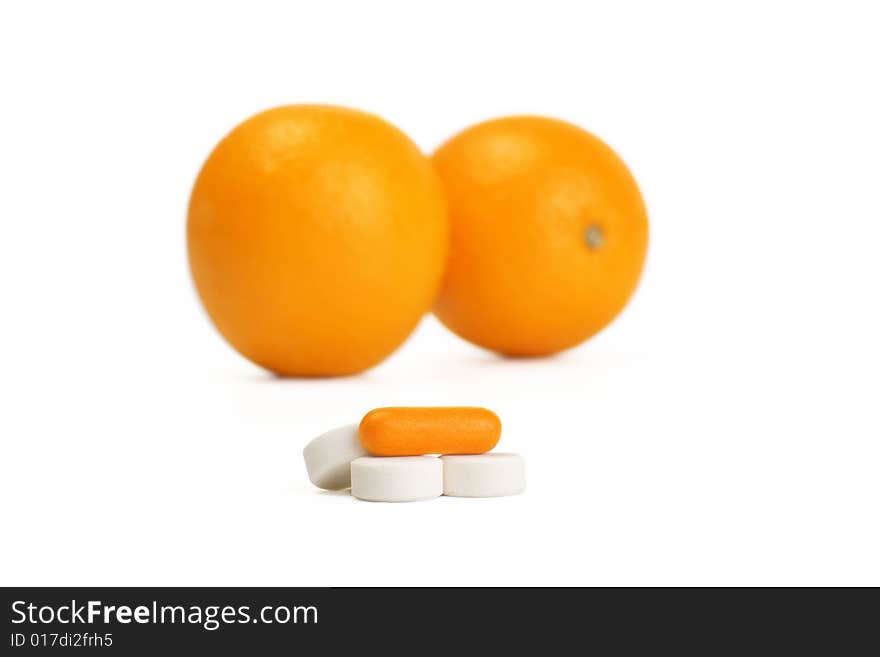 A photo of orange and pills. A photo of orange and pills