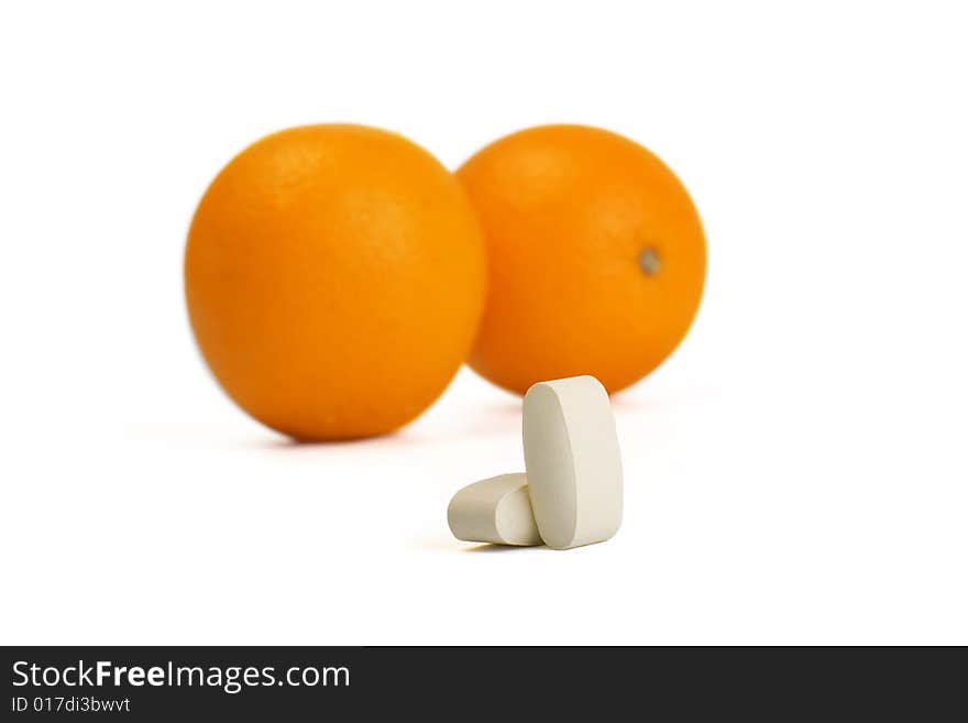 A photo of orange and pills. A photo of orange and pills