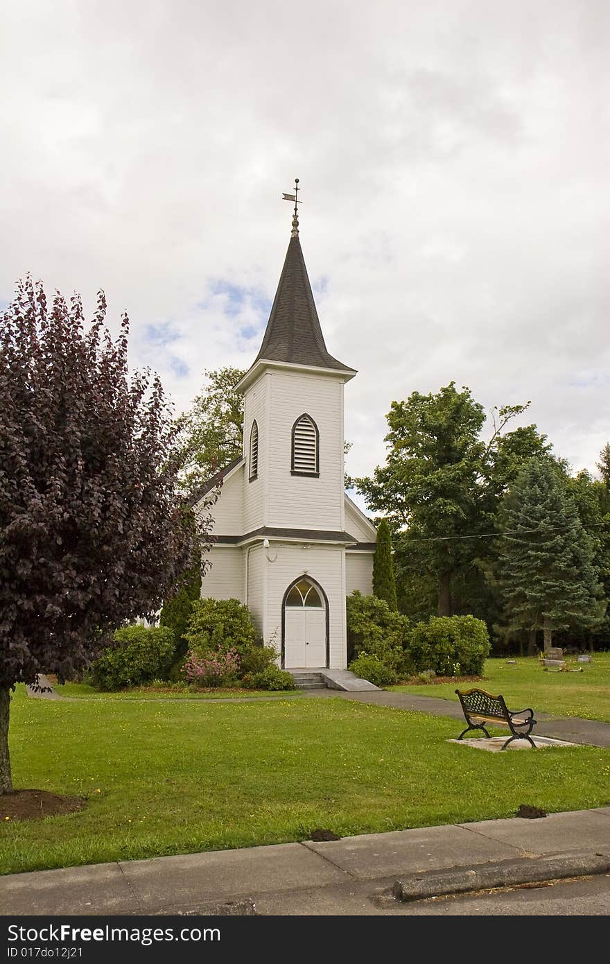 An old church with a park bench out front. An old church with a park bench out front