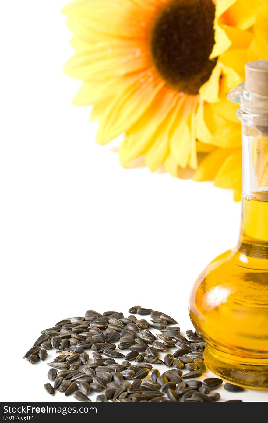 Sunflower and vegetable oil in a bottle on a white background