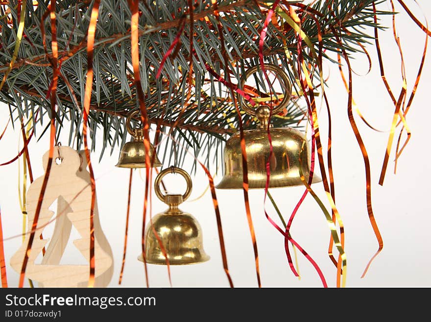 Three golden hand bells on christmas tree