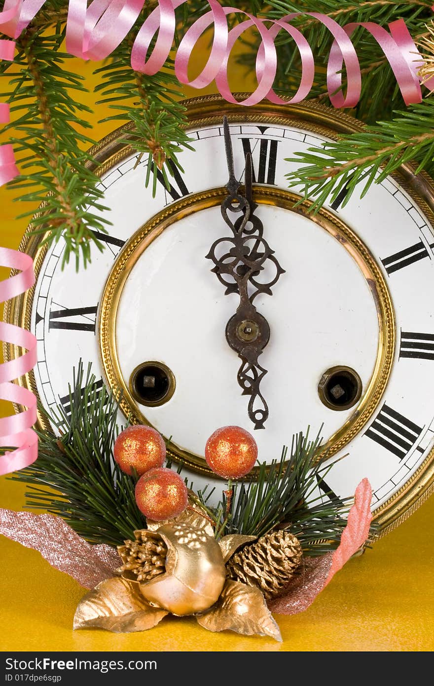 New Year's decoration with an antique clock and a firtree branch