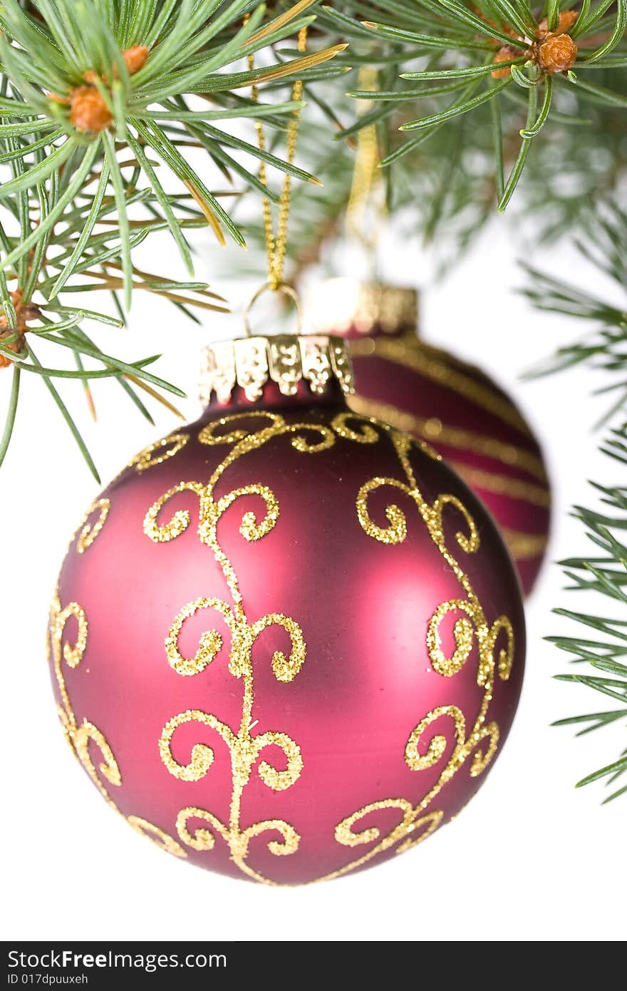 Fir tree branch with decoration on a white background. Close up. Christmas decoration.