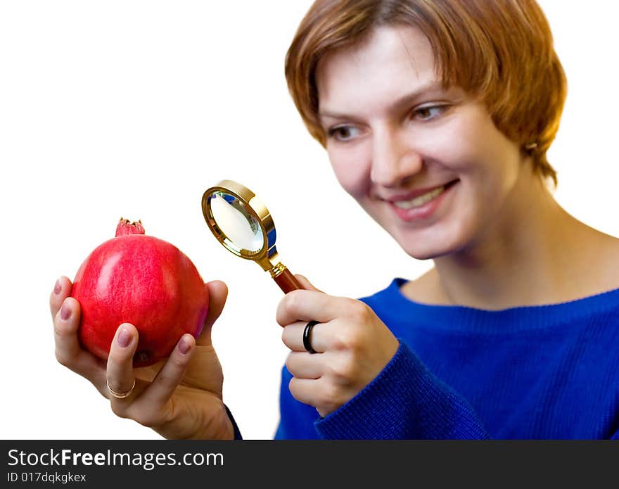 A girl with pomegranate and magnifying glass