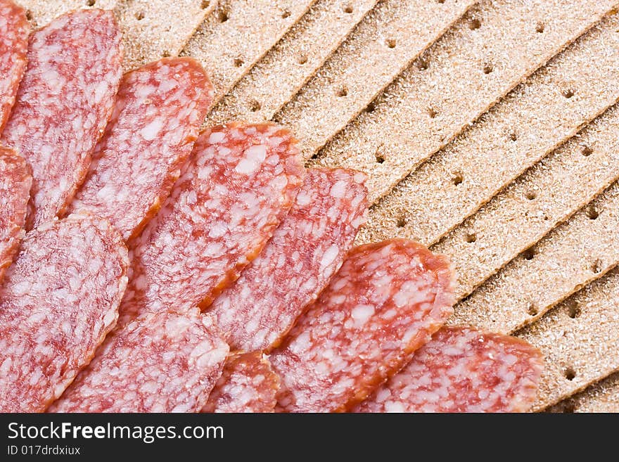 The sausage cut by slices on a dish. The sausage cut by slices on a dish