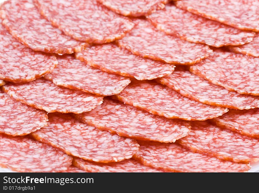 The sausage cut by slices on a dish. The sausage cut by slices on a dish