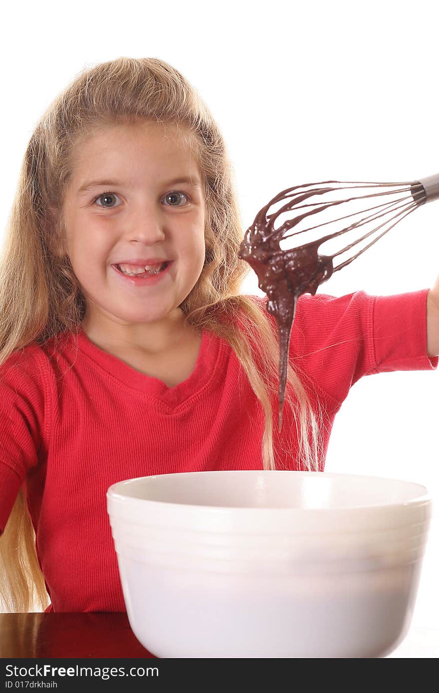 Happy little girl mixing brownie batter vertical upclose isolated on white