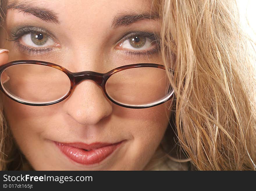 Shot of a woman pulling her glasses down - green