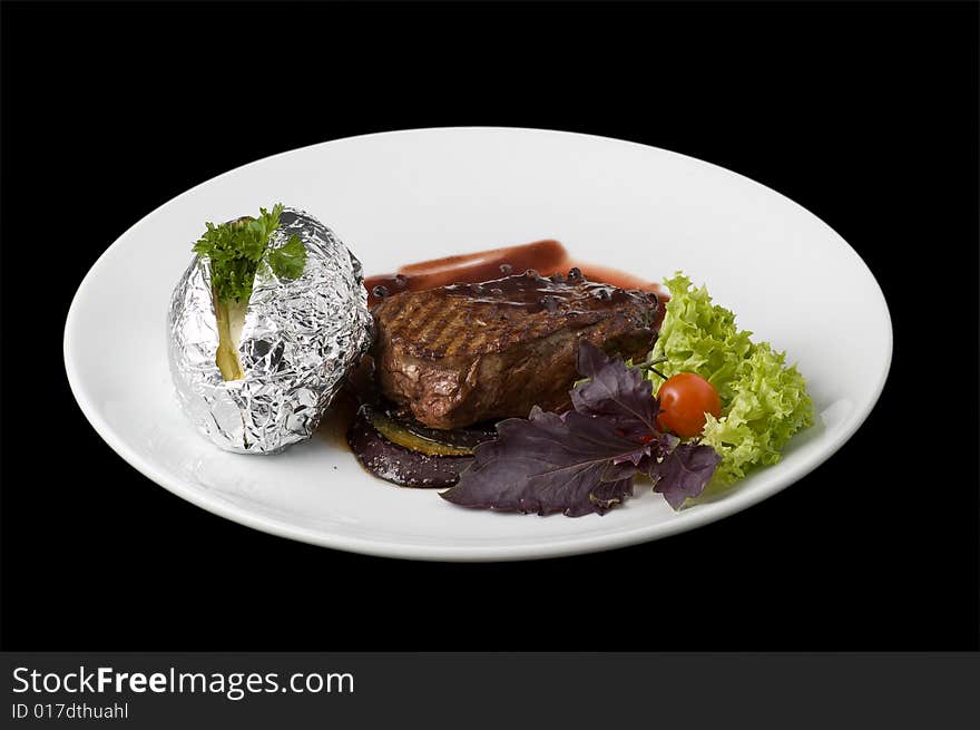 Cooked beefsteak on white plate