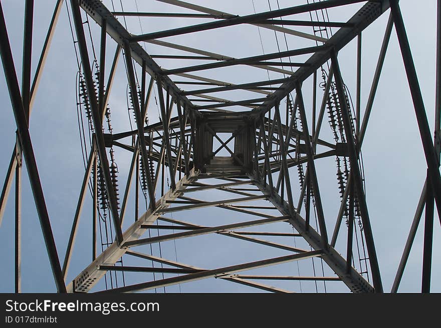 Bottom view of metal electrical pylon with wires