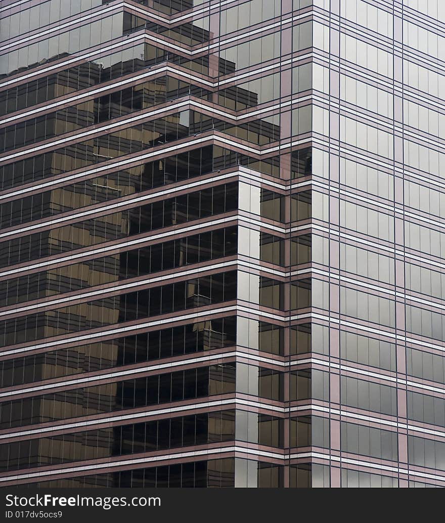 A reflective modern glass building of brown stripes. A reflective modern glass building of brown stripes