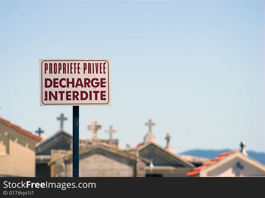 Propriete Privee, Decharge Interdite - French for  Private Area, No Unloading.
Sign outside a cemetary on Corsica, France.