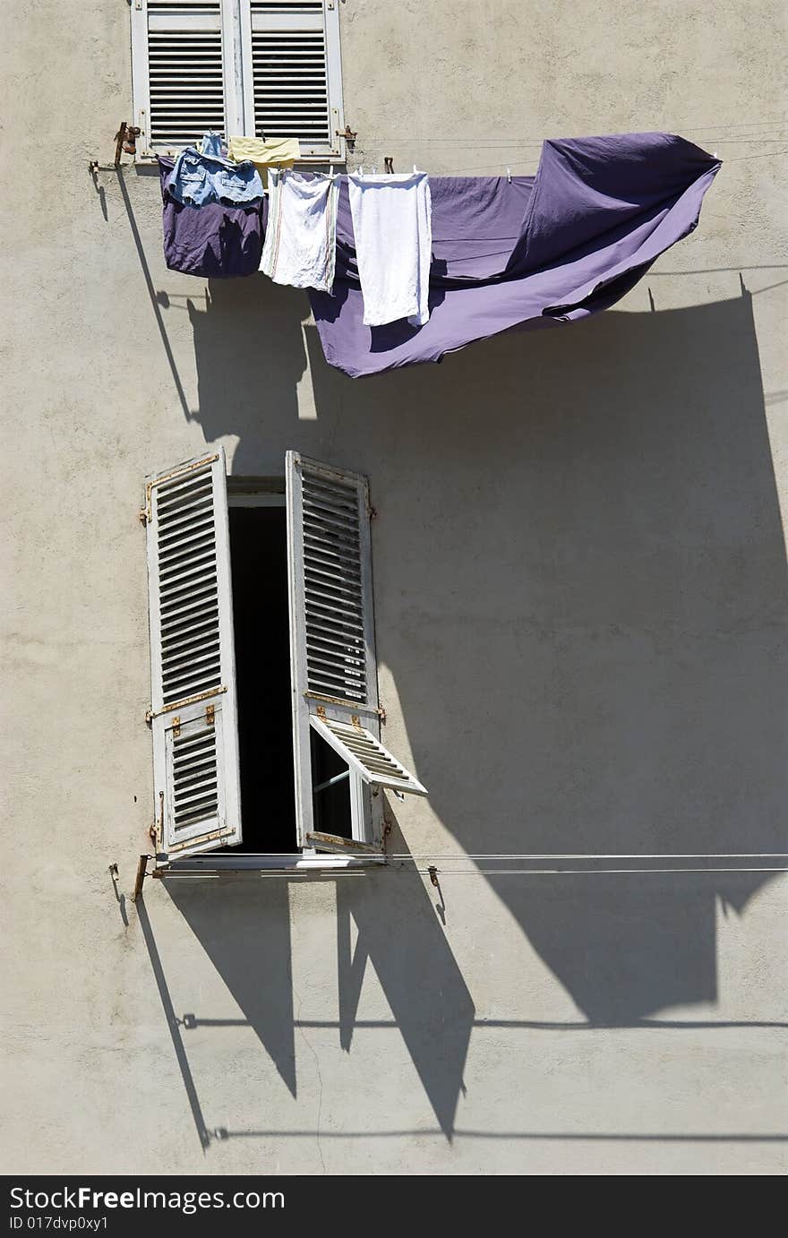 Clothesline with laundry on a wall outdoors in the wind. Clothesline with laundry on a wall outdoors in the wind