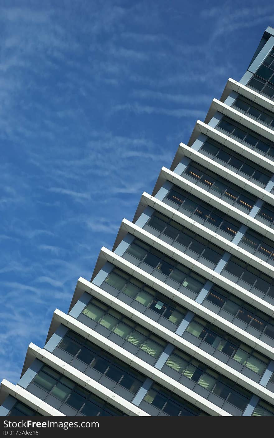 Facade of a modern industrial building backed by blue sky